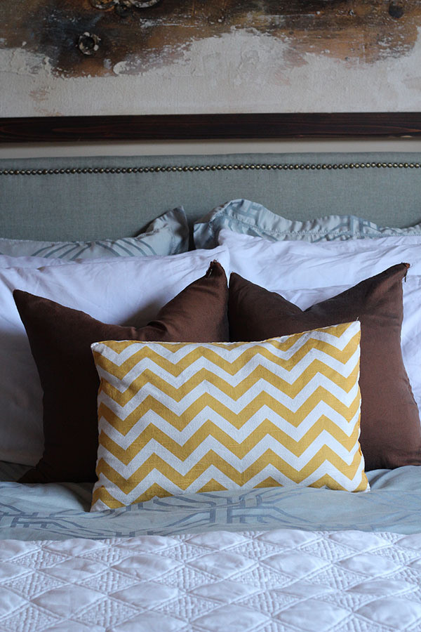 Looking to change up your headboard? Take a look at this awesome DIY Upholstered Headboard with Nailhead Trim! UpcycledTreasures.com