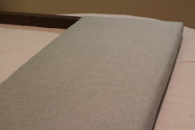 Looking to change up your headboard? Take a look at this awesome DIY Upholstered Headboard with Nailhead Trim! UpcycledTreasures.com