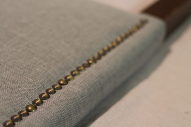 Looking to change up your headboard? Take a look at this awesome DIY Upholstered Headboard with Nailhead Trim! UpcycledTreasures.com