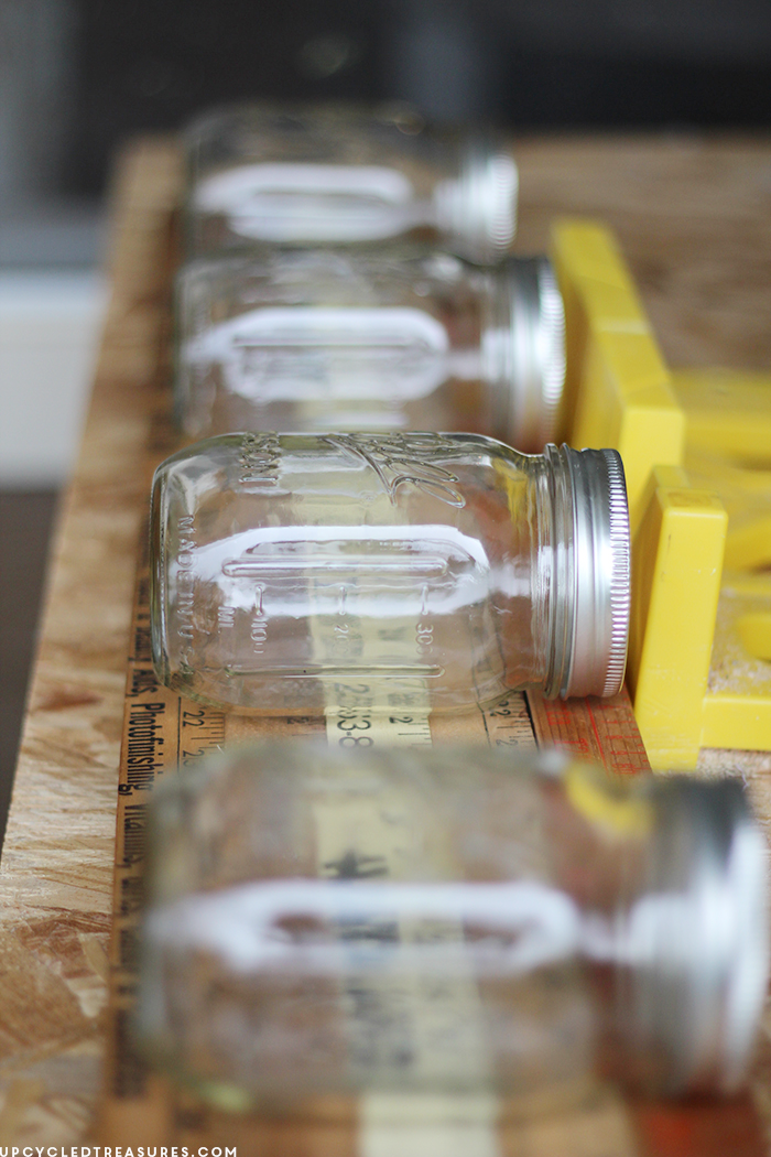 Looking for a creative storage solution? Check out how to create a mason jar wall storage using vintage yardsticks! UpcycledTreasures.com