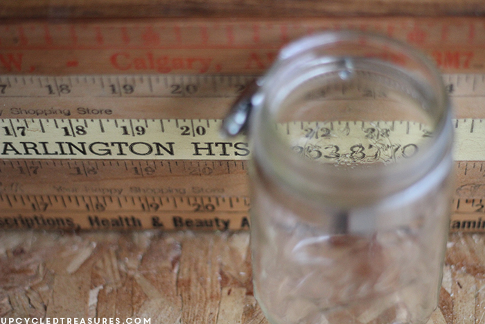 Looking for a creative storage solution? Check out how to create a mason jar wall storage using vintage yardsticks! UpcycledTreasures.com