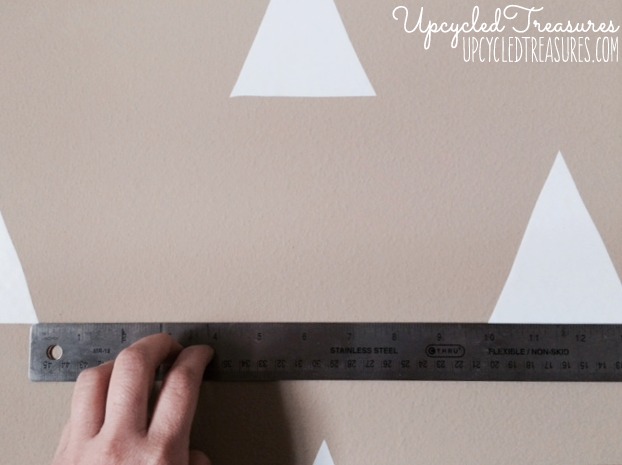 Looking to spruce up your walls in a rental property? Check out how to create a temporary DIY triangle accent wall for Less than $3! UpcycledTreasures.com