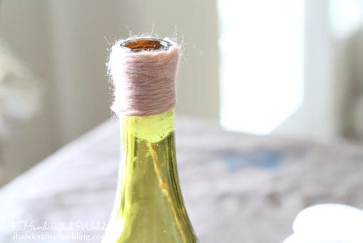 Check out how to upcycle bottles into Yarn Wrapped Bottle Vases or Table Numbers for your Wedding Reception Decor | MountainModernLife.com