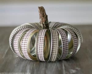 Create these adorable DIY fabric tape pumpkins by wrapping faux pumpkins with fabric tape! MountainModernLife.com