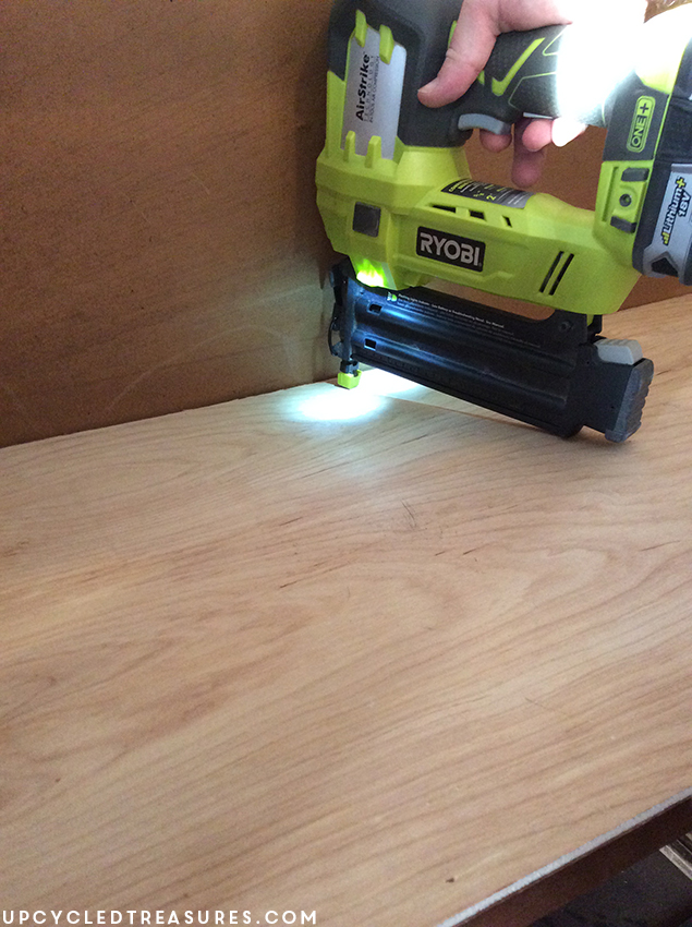 using-ryobi-nail-gun-to-attach-plywood-inside-armoire-upcycledtreasures