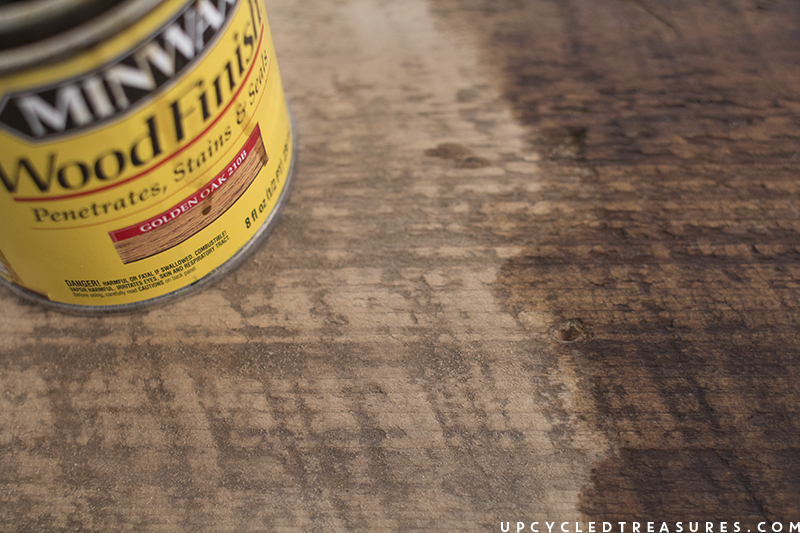 using-golden-oak-stain-on-salvaged-barnwood-upcycledtreasures Give old wood new life by reimagining it into a modern rustic wall hanging! This project is super easy and is fun way to display lanterns and plants. MountainModernLife.com