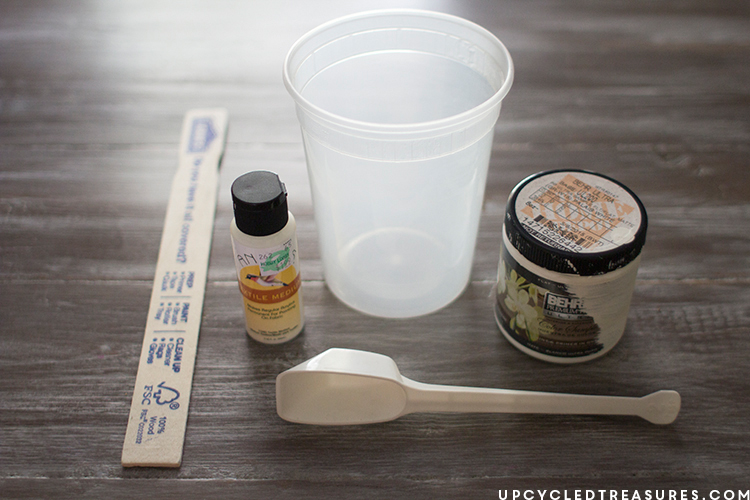 Supplies used for Kilim inspired painted pillow including paint, empty container, textile medium, stir stick, and measuring spoon. MountainModernLife.com