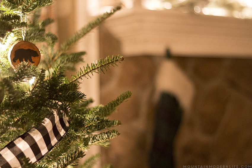 See how easy it is to create these rustic cabin Inspired Christmas ornaments from wood slices. Plus Download the FREE printable designs to use on your own holiday ornaments. mountainmodernlife.com