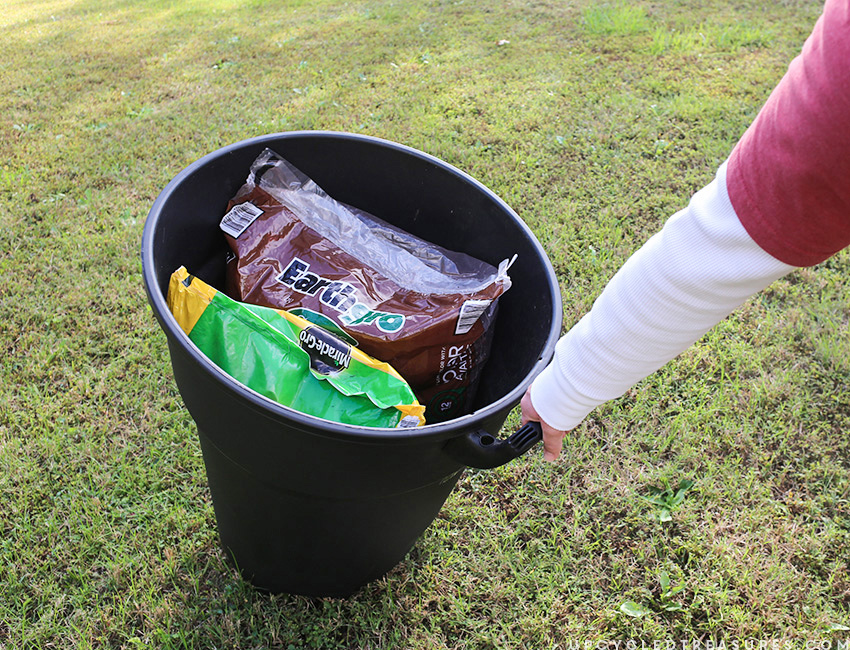 Using trash can with wheels to haul mulch around yard. MountainModernLife.com