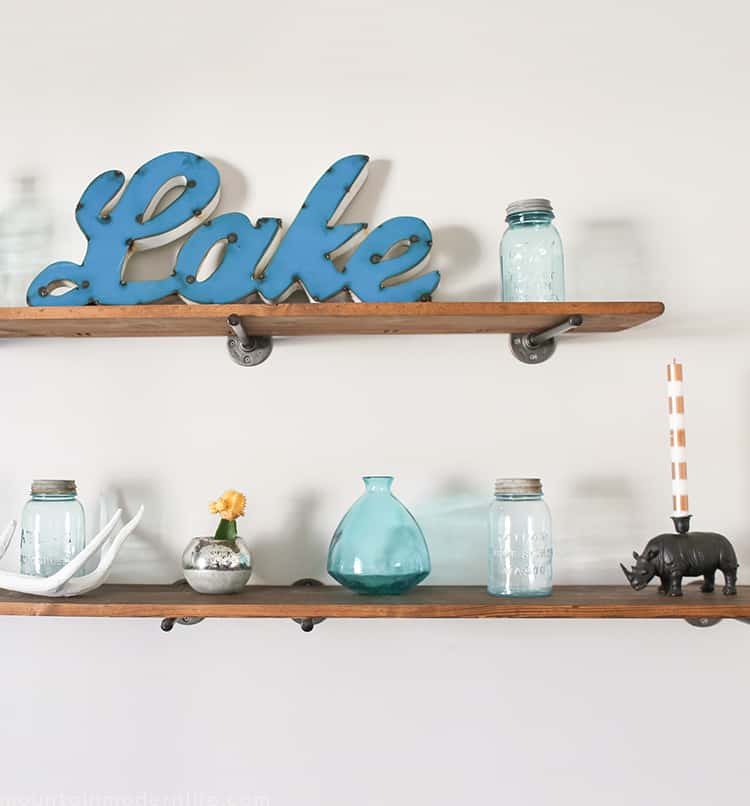 Looking to create shelves with little to no tools? See how you can easily create these Rustic Modern Shelves using pipes! MountainModernLife.com