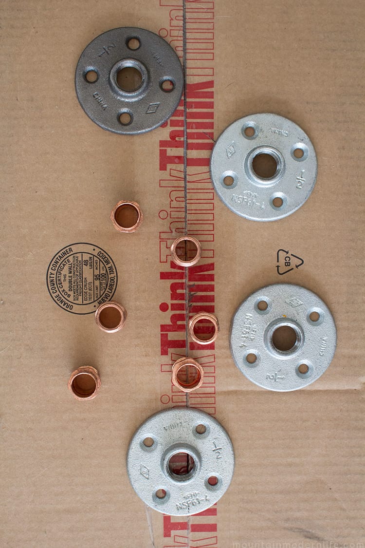 Looking to create shelves with little to no tools? See how you can easily create these Rustic Modern Shelves using pipes! MountainModernLife.com