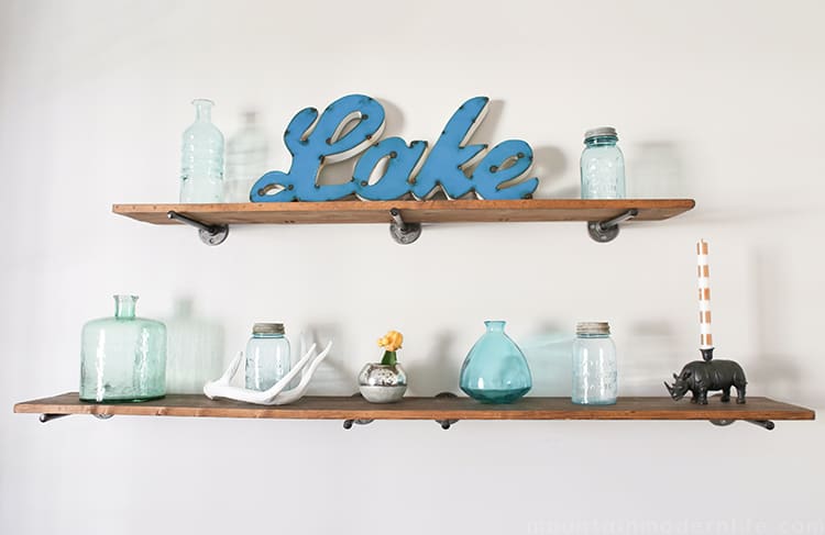 Looking to create shelves with little to no tools? See how you can easily create these Rustic Modern Shelves using pipes! MountainModernLife.com
