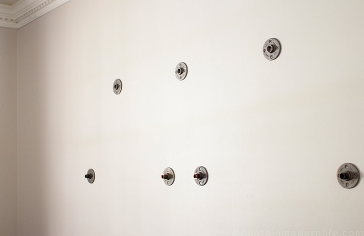 Looking to create shelves with little to no tools? See how you can easily create these Rustic Modern Shelves using pipes! MountainModernLife.com