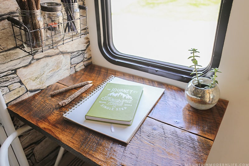 See how we added character and function to our RV by creating a wall-mounted desk from reclaimed wood. MountainModernLife.com