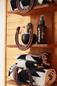 diy horseshoe shelf in bathroom ith rusty patina