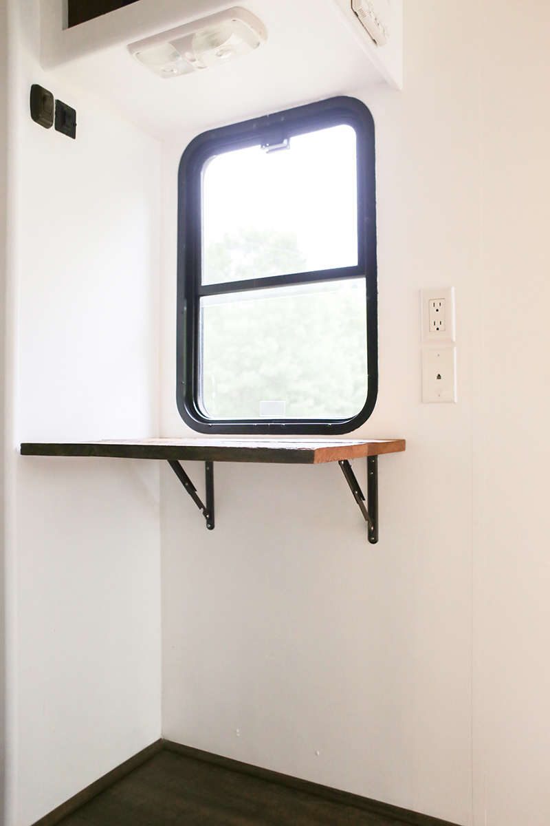 Save Space and add character to your home with a reclaimed wall-mounted desk that flips down when not in use. This is perfect for creating a workspace in an RV! MountainModernLife.com 