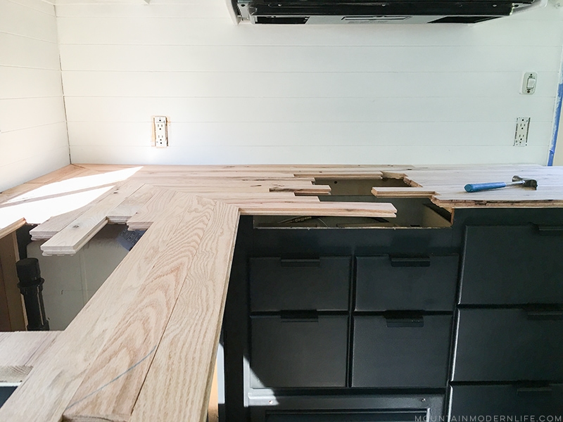 installing-affordable-wood-counters-in-rv-from-flooring-mountainmodernlife.com Looking for an affordable way to update your kitchen counters? Check out this post on how to Create Wood Counters from Flooring in a RV! MountainModernLife.com