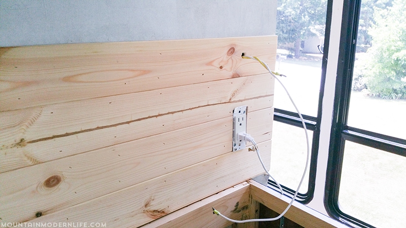 Easily install a wood planked kitchen backsplash in a RV! This is the perfect way to add rustic modern or farmhouse style to your tiny home on wheels!