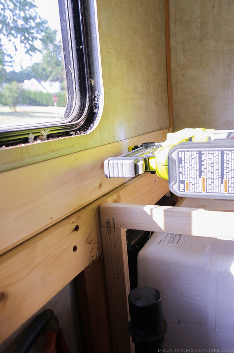 Easily install a wood planked kitchen backsplash in a RV! This is the perfect way to add rustic modern or farmhouse style to your tiny home on wheels!