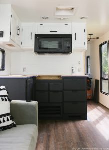 Easily install a wood planked kitchen backsplash in a RV! This is the perfect way to add rustic modern or farmhouse style to your tiny home on wheels!