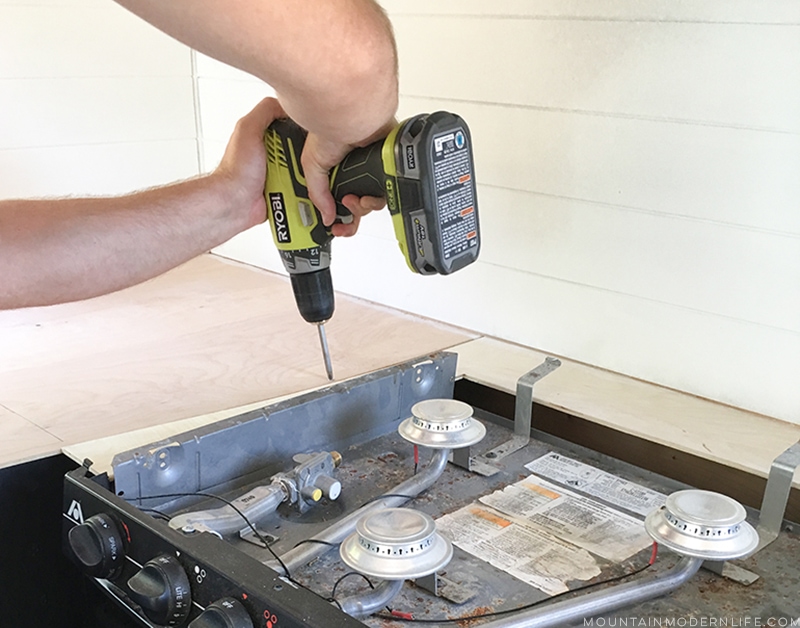 screwing-plywood-base-down-for-counters-in-rv-mountainmodernlife.com Looking for an affordable way to update your kitchen counters? Check out this post on how to Create Wood Counters from Flooring in a RV! MountainModernLife.com