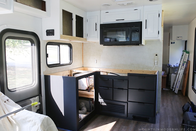 updating-kitchen-backsplash-in-rv-mountainmodernlife.com Looking for an affordable way to update your kitchen counters? Check out this post on how to Create Wood Counters from Flooring (in a RV)! MountainModernLife.com