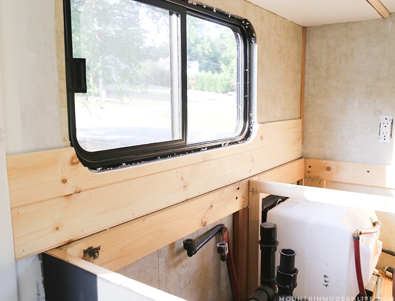 Easily install a wood planked kitchen backsplash in a RV! This is the perfect way to add rustic modern or farmhouse style to your tiny home on wheels!