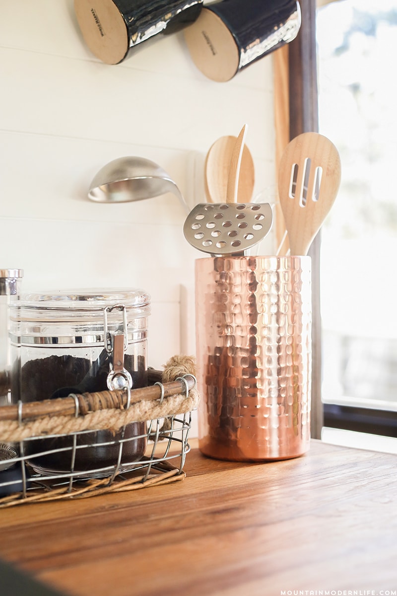 copper-accents-in-tiny-kitchen-mountainmodernlife.com Could you live in less than 300 square feet? See how this outdated motorhome was completely transformed into a rustic modern RV! MountainModernLife.com