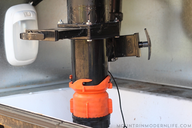 sewer-hose-connected-to-RV-dump-station-mountainmodernlife.com