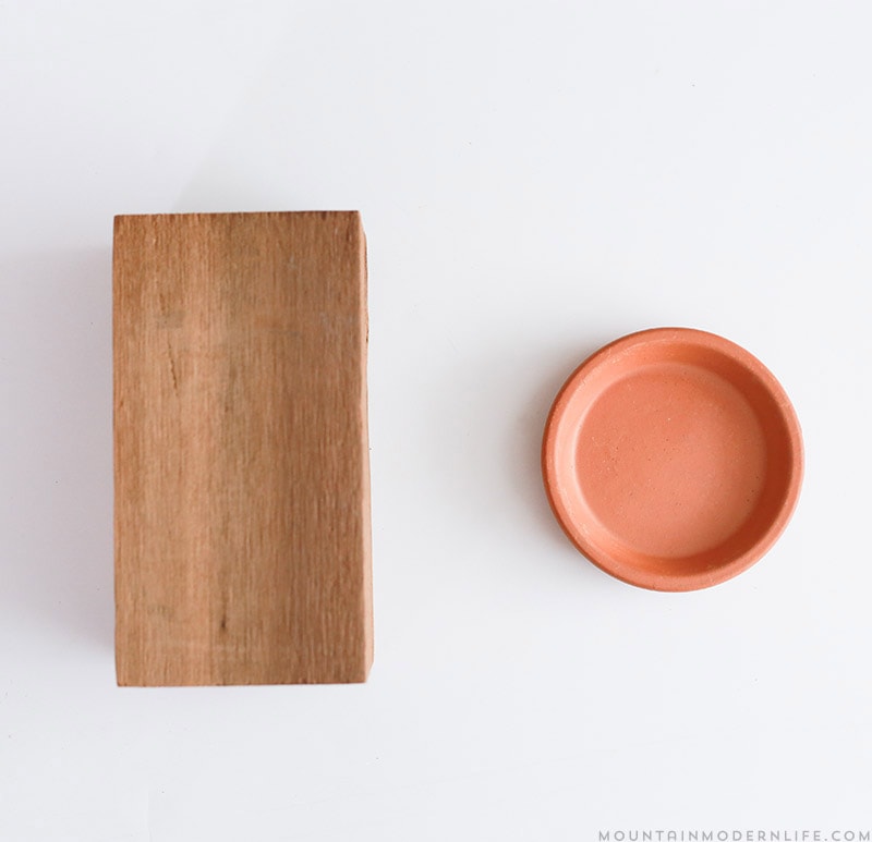 See how easy it is to make these Rustic Modern Candle Holders using scrap wood and terra cotta clay saucers! MountainModernLife.com