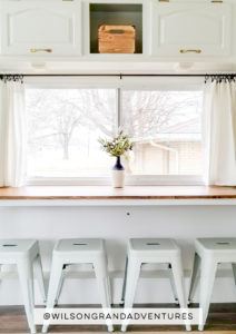 Tour this remodeled RV filled with lots of white, shiplap, and warm wood tones from @WilsonGrandAdventures! Featured on MountainModernLife.com