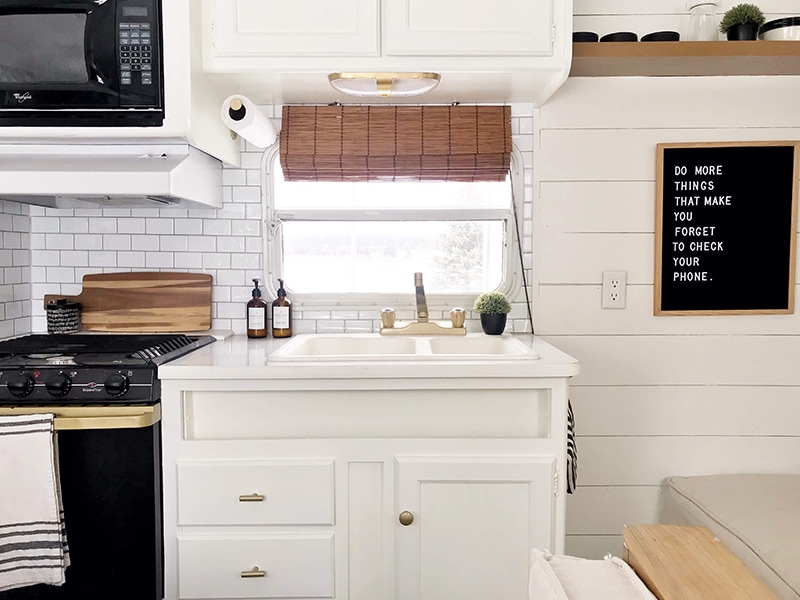 Tour this budget-friendly farmhouse camper that was transformed for $500 by Proverbs31Girl! Featured on MountainModernLife.com