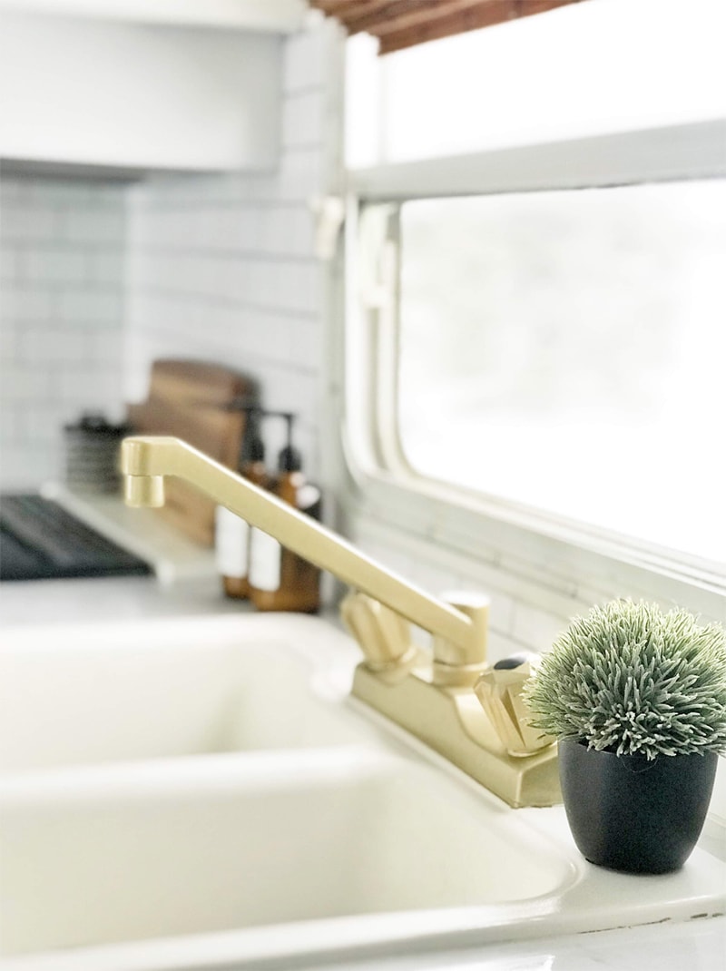 Tour this budget-friendly farmhouse camper that was transformed for $500 by Proverbs31Girl! Featured on MountainModernLife.com