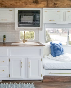 Tour this modern yet cozy renovated RV filled with lots of white, shiplap, and warm wood tones from @WilsonGrandAdventures! Featured on MountainModernLife.com