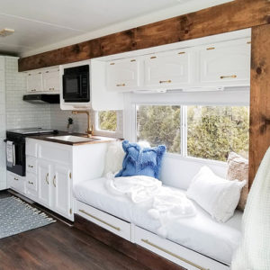 Tour this modern yet cozy renovated RV filled with lots of white, shiplap, and warm wood tones from @WilsonGrandAdventures! Featured on MountainModernLife.com