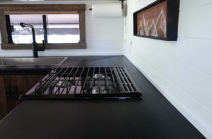 Considering adding black kitchen countertops to your home? Come see how we updated butcher block countertops for a rustic modern vibe in our RV. MountainModernLife.com