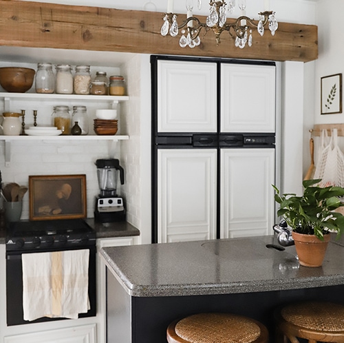 Tour this modern RV with old world charm from @r.maria.fuller that has wood beams that will make you swoon! See the before and after on MountainModernLife.com