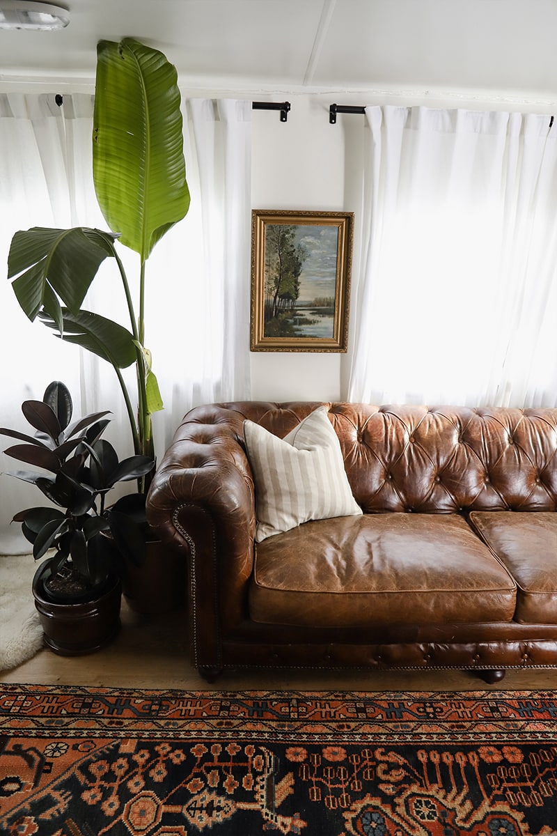 Tour this modern RV with old world charm from @r.maria.fuller that has wood beams that will make you swoon! See the before and after on MountainModernLife.com