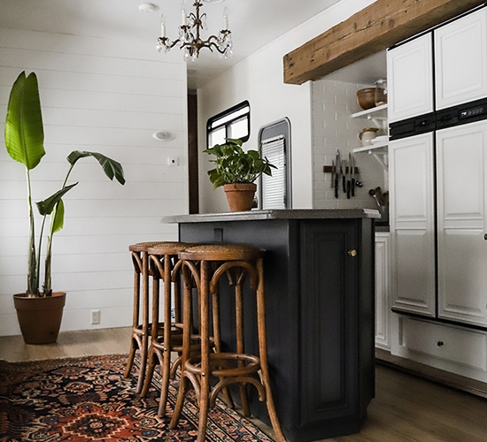 Tour this modern RV with old world charm from @r.maria.fuller that has wood beams that will make you swoon! See the before and after on MountainModernLife.com