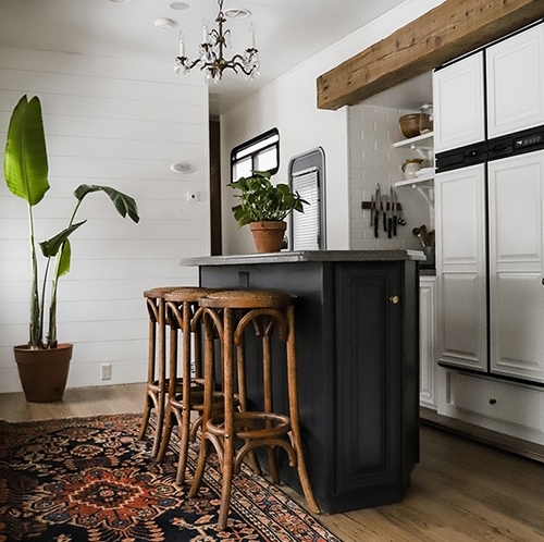 Tour this modern RV with old world charm from @r.maria.fuller that has wood beams that will make you swoon! See the before and after on MountainModernLife.com