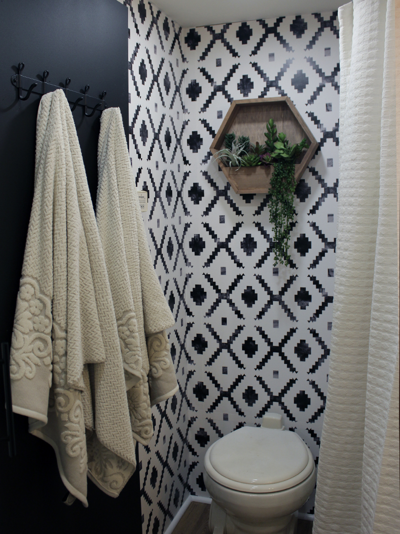 This remodeled RV has the coziest fireplace you've ever seen in a tiny home). Featuring @karleeandweston on MountainModernLife.com