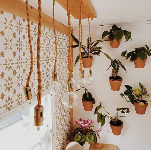 The interior of this bohemian 5th wheel is a botanical wonderland! Featuring @leeannieblivin on mountainmodernlife.com