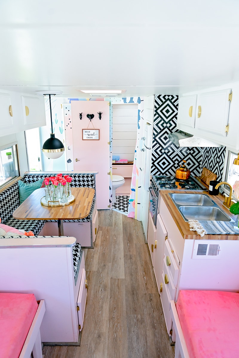 The playful interior of this vintage camper renovation was inspired by abstract pop wallpaper