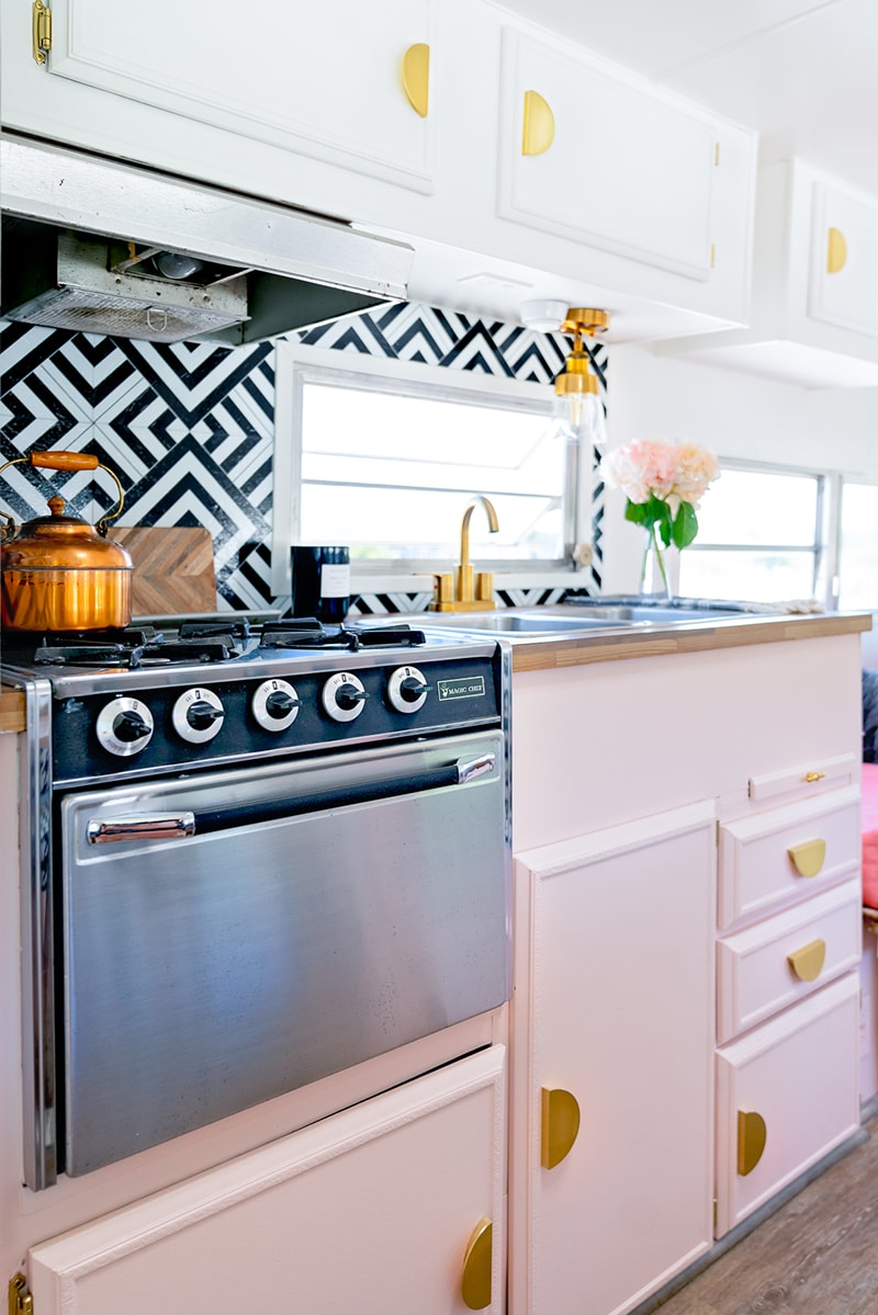 The playful interior of this vintage camper renovation was inspired by abstract pop wallpaper