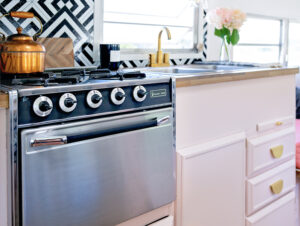 camper oven and pink kitchen cabinets