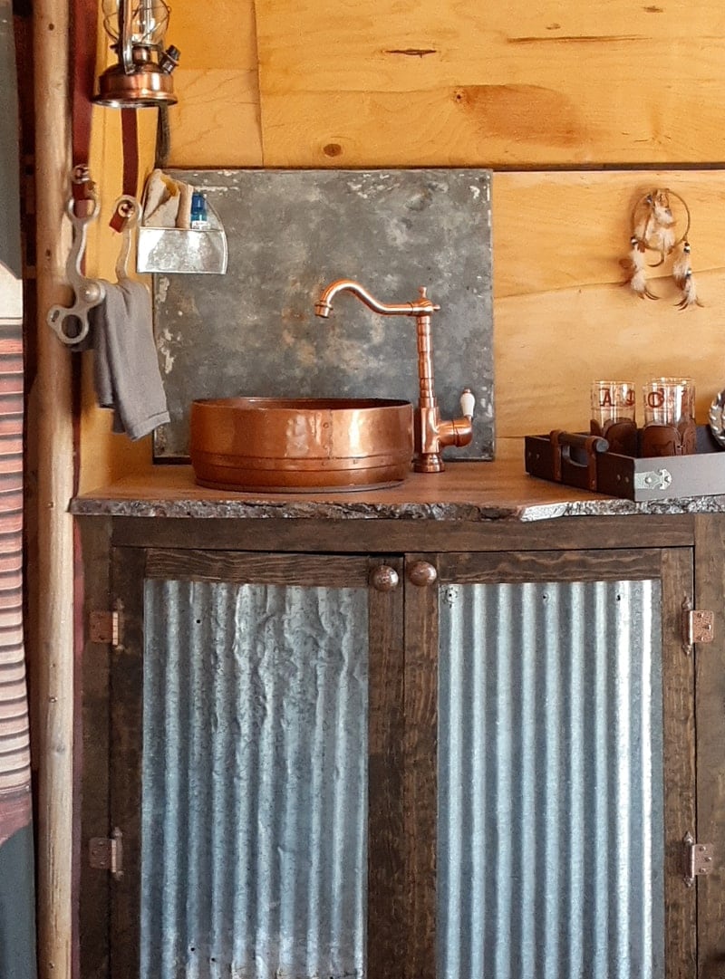 western camper kitchen with copper sink and corrugated metal