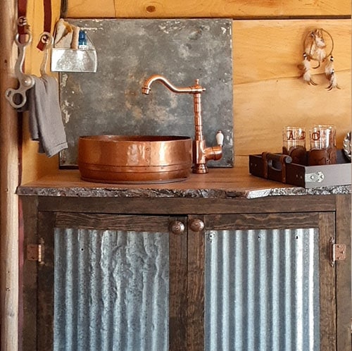 rustic camper kitchen with copper sink and corrugated metal