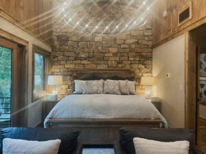 stone accent wall in mountain home bedroom